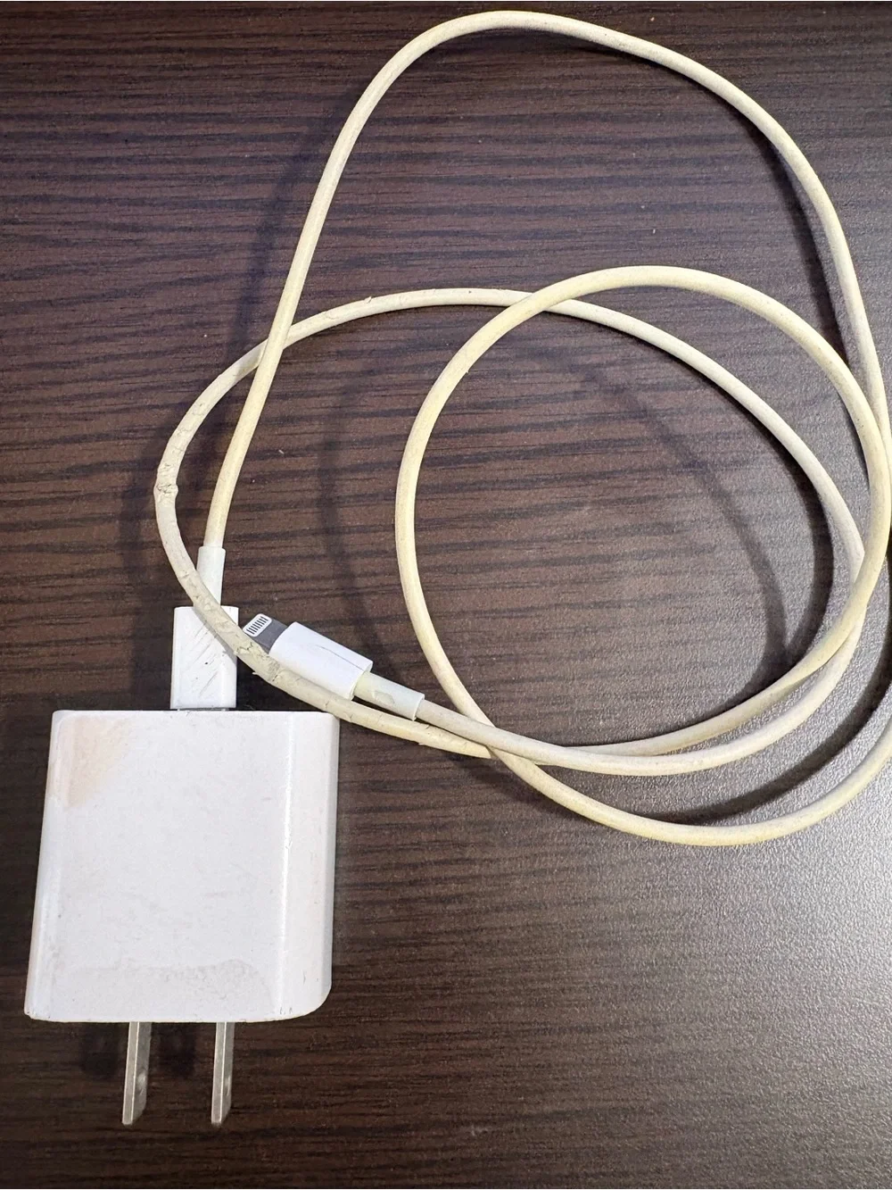 White Smartphone with White Charging Cable and Wall Adapter